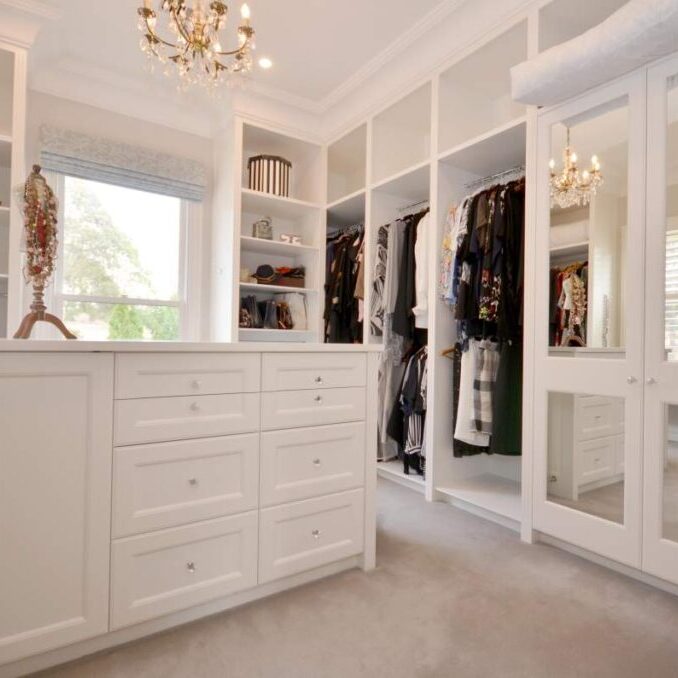 Lemlex joinery has created this elegant walk-in wardrobe with classic style dresser and mirror doors